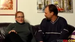 Molliges Paar mit Tätowierungen auf Ledercouch, Frau reitet Mann.
